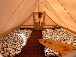 a bedroom with two beds in a tent at Aparra Surfcamp Saint-Jean-de-Luz in Saint-Jean-de-Luz