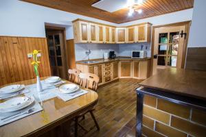 a kitchen with a table with plates on it at Estate Žagmeštri in Ljubno