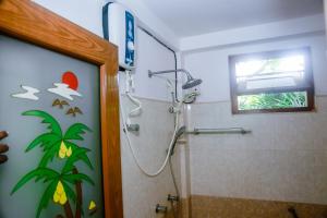 a bathroom with a shower with a glass door at Ranjith Guest in Mirissa