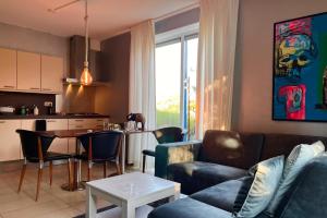 a living room with a couch and a table at Wellness Suites Dellewal in West-Terschelling