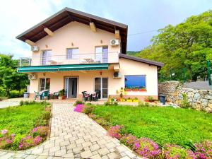 a house with a balcony and a patio at Makach Apartments in Ohrid