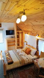 a bedroom with a bed and a wooden ceiling at Apartments Sipcic in Žabljak