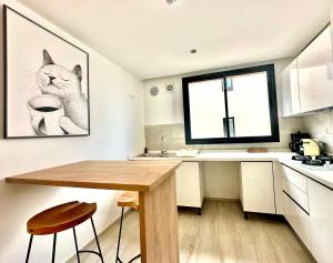 uma cozinha com uma mesa de madeira e uma foto de gato em A12 stylish and modern 2bds in La Marsa em La Marsa