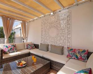 a living room with a couch and a table at Villa Harvey in Albufeira
