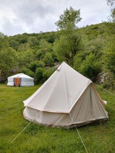 a white tent in a field of grass at Tente style Tepee Confort in Latour-de-Carol