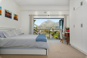 a bedroom with a bed and a view of a mountain at Albert Road 14 in Cape Town