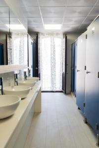 a bathroom with four sinks and a large window at HOSTEL PRIME in Benicàssim