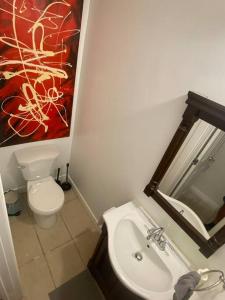 a bathroom with a toilet and a sink and a mirror at Luxury North Vancouver 3 bedroom Up Level House in North Vancouver