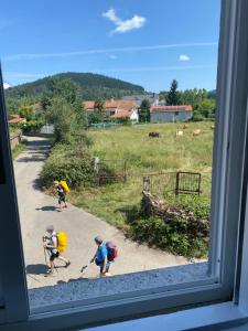 a group of children are walking down a road at Casa Roque in Monforte de Lemos