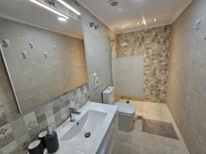 a bathroom with a sink and a toilet and a mirror at HDA apartment 2. in Torrevieja +22 photos