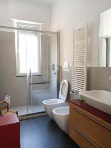 a bathroom with a toilet and a sink and a shower at Casa Oliveta in Rapallo