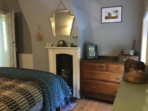 um quarto com uma cama, uma cómoda e um espelho em Holly cottage Wold Newton, near Yorkshire coast em Wold Newton