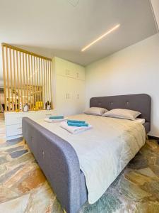 a bedroom with a large bed with two towels on it at Lemon Tree Villa in Chalkida