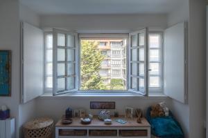 a room with two windows and a table and a chair at CASTEL SAINT CLAIR in Deauville