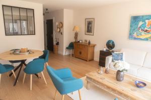 a living room with a white couch and a table at CASTEL SAINT CLAIR in Deauville