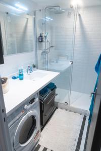 a bathroom with a washing machine and a shower at CASTEL SAINT CLAIR in Deauville
