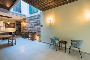 a lobby with chairs and tables and a stone wall at Entire house 3 bedrooms in Victoria