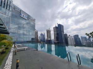 a swimming pool with a view of a city skyline at Dorsett Bukit Bintang Residence by De Space in Kuala Lumpur
