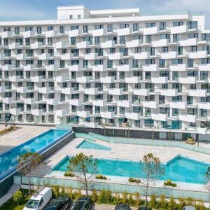an apartment building with two pools and a parking lot at David & Andrei Infinity in Mamaia Nord
