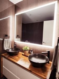 a bathroom with two sinks and a large mirror at The Nines in Wollongong
