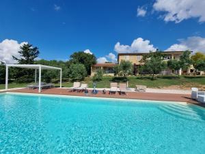 a swimming pool with chairs and a house at Aldo Bed & Beauty country house in Arzachena