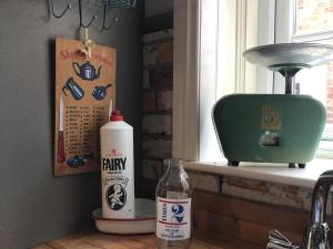a bottle of milk sitting on a counter next to a window at Holly cottage Wold Newton, near Yorkshire coast in Wold Newton