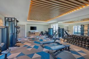 a gym with several treadmills and machines in a room at Element by Marriott Al Jaddaf, Dubai in Dubai