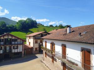 a group of buildings with hills in the background at Amaiurko Aterpetxea in Maya del Baztán