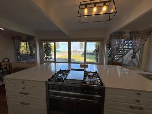 a kitchen with a stove and a counter top at Bells Beach Bungalow in Clontarf