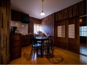 - une cuisine avec une table et des chaises dans la chambre dans l'établissement Musashi Machiya ni, à Kyoto