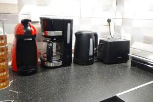 a kitchen counter with a coffee maker and a coffee pot at Forest Apartment Salonica in Thessaloniki +50 photos