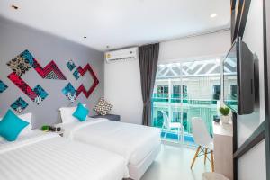 Ένα ή περισσότερα κρεβάτια σε δωμάτιο στο The Crib Patong - SHA Certified