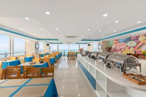 a dining room with blue tables and chairs at Blue Pearl Hotel in Nha Trang