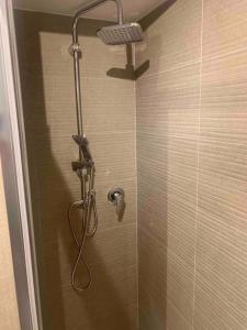 a shower with a shower head in a bathroom at Appartamento al civico 16 in Licata