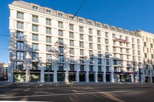 a large white building on a city street at Premier Inn Leipzig City Oper in Leipzig