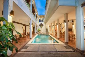 an indoor swimming pool in the middle of a building at Sedasa Lodge in Canggu