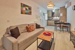 a living room with a couch and a table at Redo Home El Pópulo in Cádiz