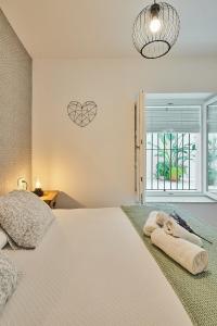 a bedroom with a large bed and a window at Redo Home Little Apartments in Cádiz