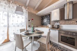 a kitchen with a table and chairs in a kitchen at La Dolce Vita - Vista Lago e Piscina in Parzanica
