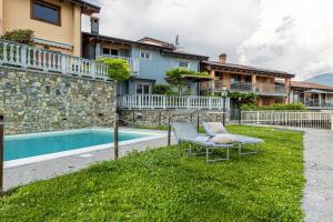 a backyard with a table and a swimming pool at La Dolce Vita - Vista Lago e Piscina in Parzanica
