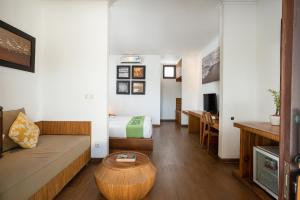 a living room with a couch and a table at Sedasa Lodge in Canggu