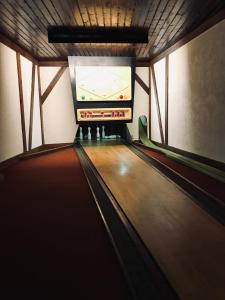 an image of a bowling alley with avertisement at Gasthof zur Post Hotel - Restaurant in Breckerfeld