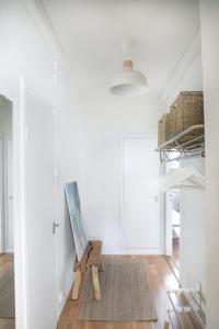 a room with a painting on the wall and a wooden chair at Studio-Joki - Valoisa asunto keskustassa in Turku