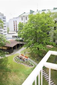 a view of a park from the balcony of a building at Studio-Joki - Valoisa asunto keskustassa in Turku