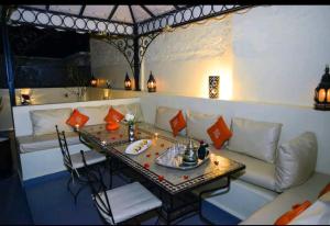 a living room with a white couch and a table at Riad Des ours in Marrakesh