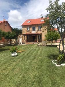 a house with a large yard with a grass yard at Casa de Romaxe in Muros