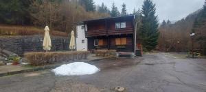 a house with a lot of snow in front of it at Penzion Svojanov in Svojanov