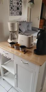 a kitchen counter with a mixer and bowls on it at Maison en bord de mer in Le Barcarès