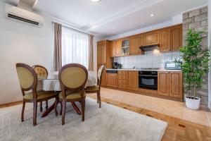kuchnia z drewnianymi szafkami oraz stołem i krzesłami w obiekcie Apartment Iva with sea view w Makarskiej