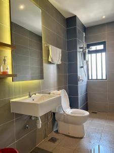 a bathroom with a sink and a toilet at Cozy Hyve Soho Suites in Cyberjaya